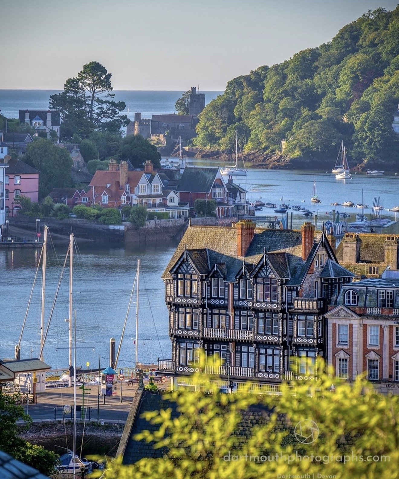 Dartmouth harbour with colourful boats moored along the waterfront